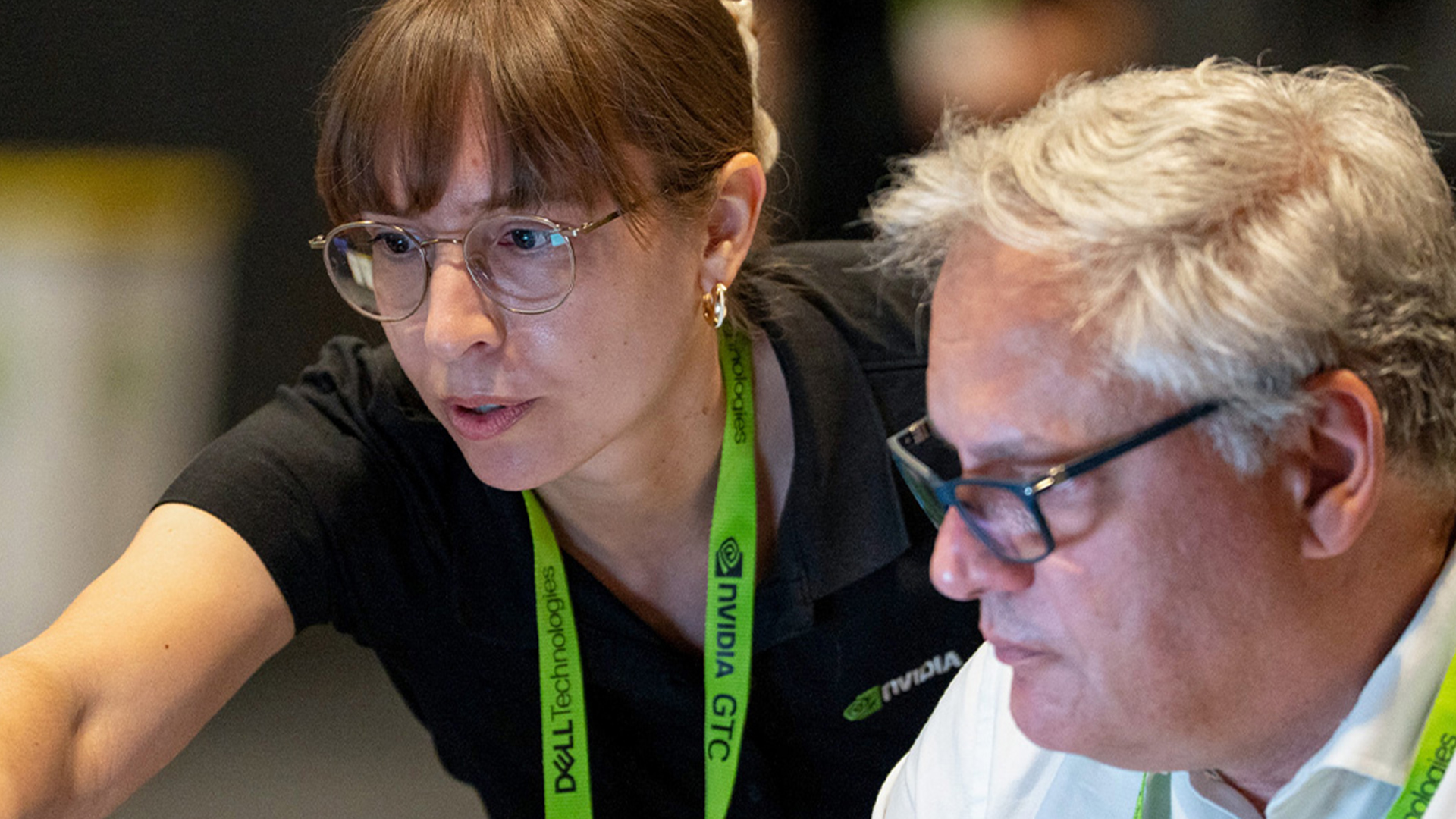 An expert instructor teaches a developer at a GTC workshop